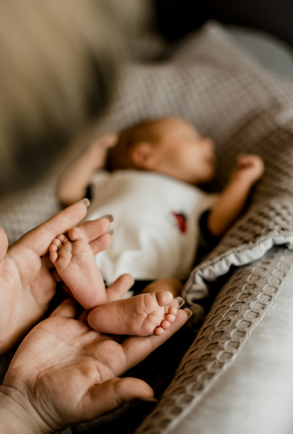 a person holding a baby in their hands