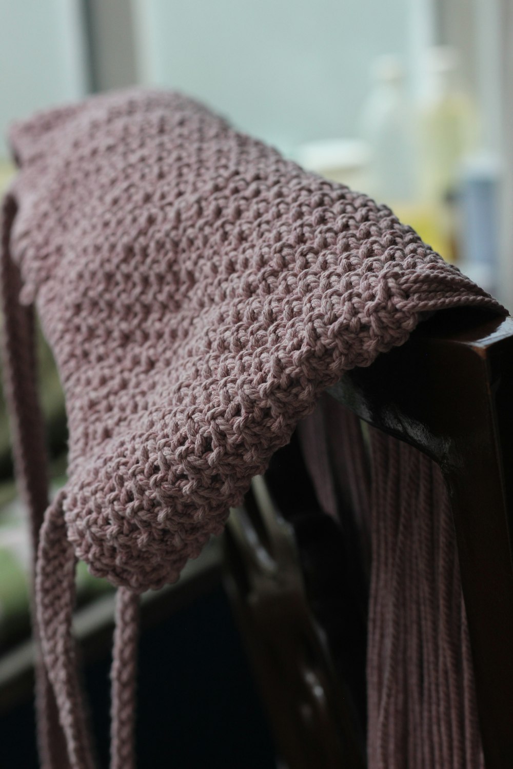 pink knit textile on brown wooden table