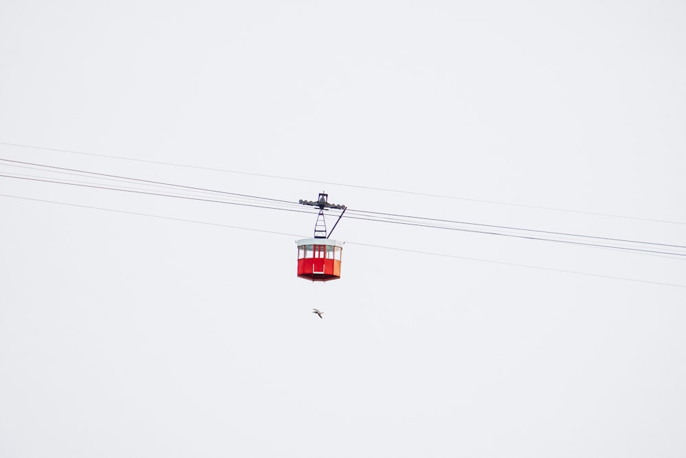 red cable car under white sky