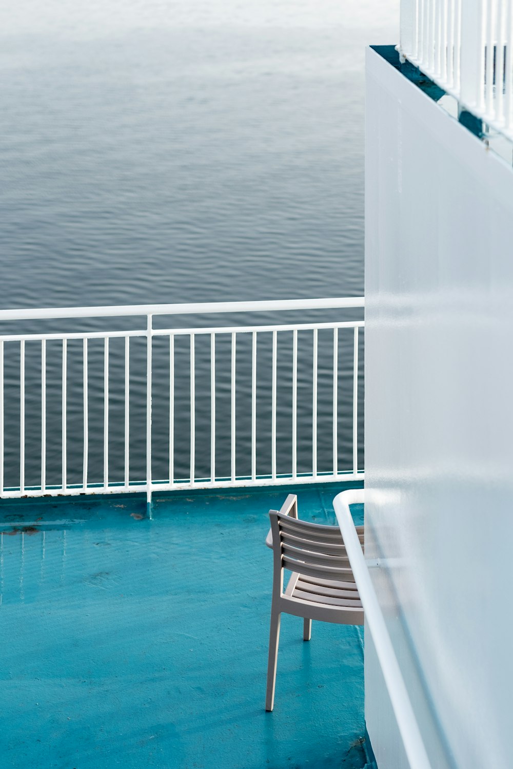 white wooden chair on blue swimming pool