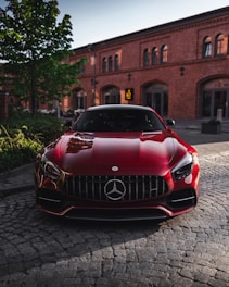 red bmw car parked on street during daytime