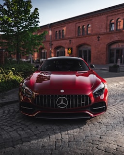 red bmw car parked on street during daytime