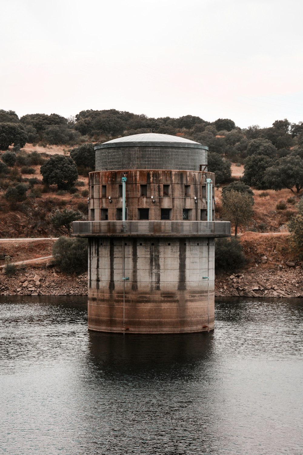 brown and white concrete building near body of water during daytime