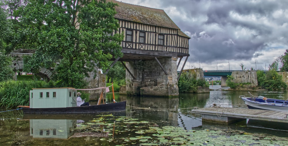 brown wooden house on water