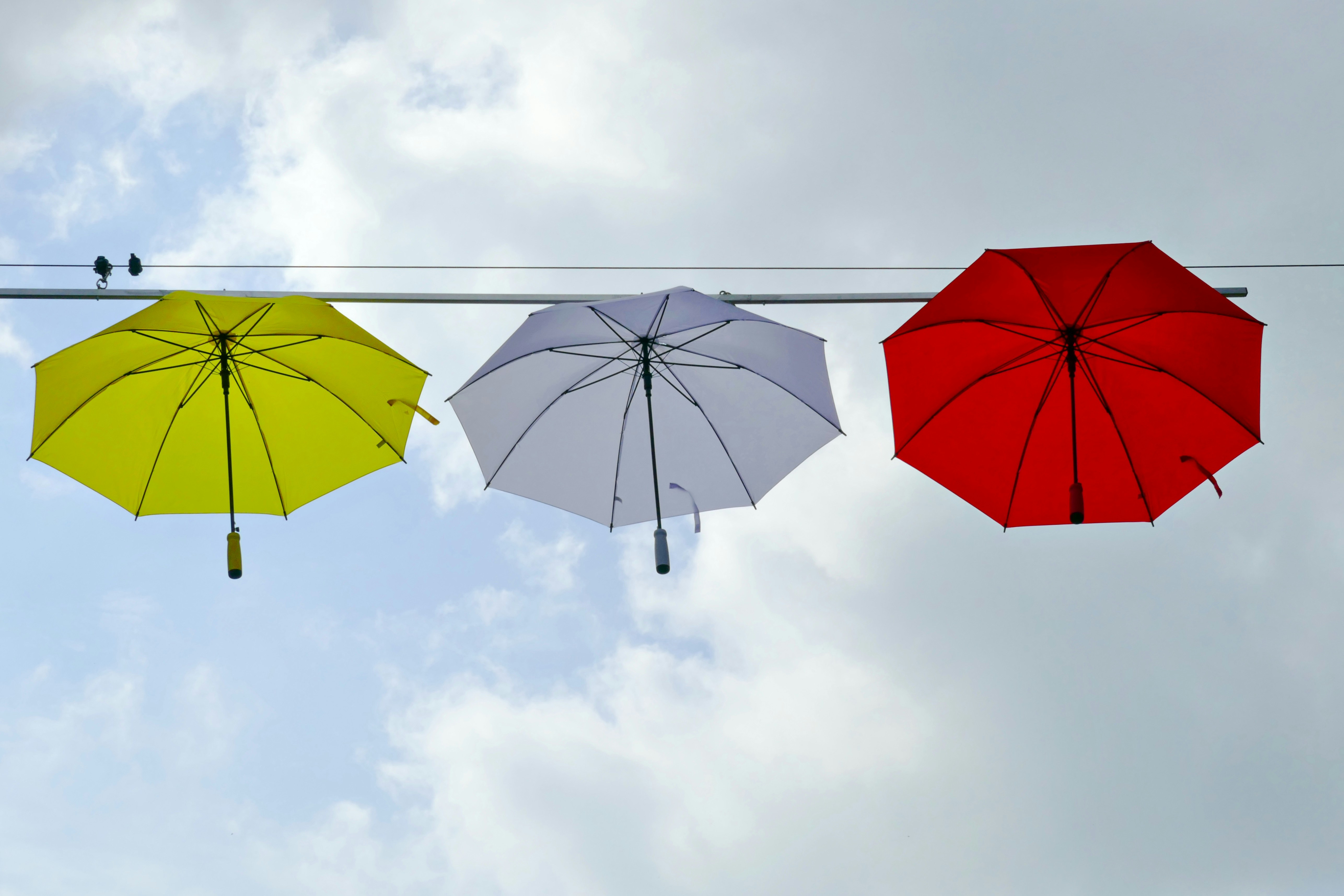 red umbrella under white clouds