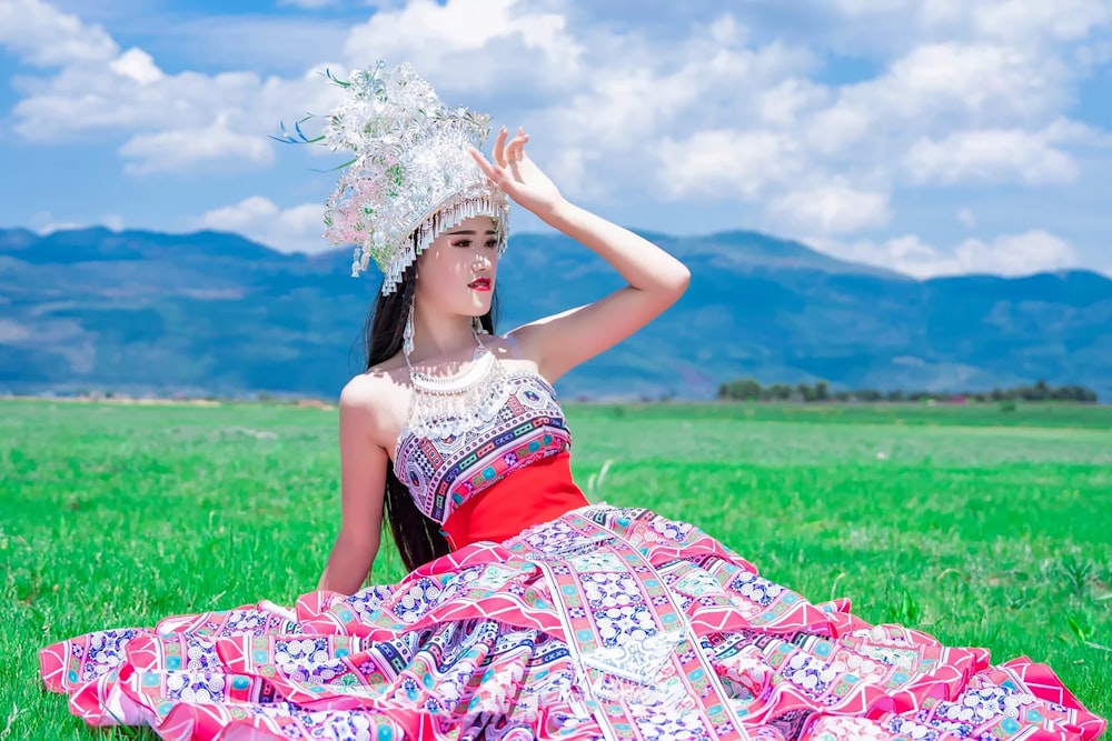 woman in red and white floral tube dress wearing white floral headdress