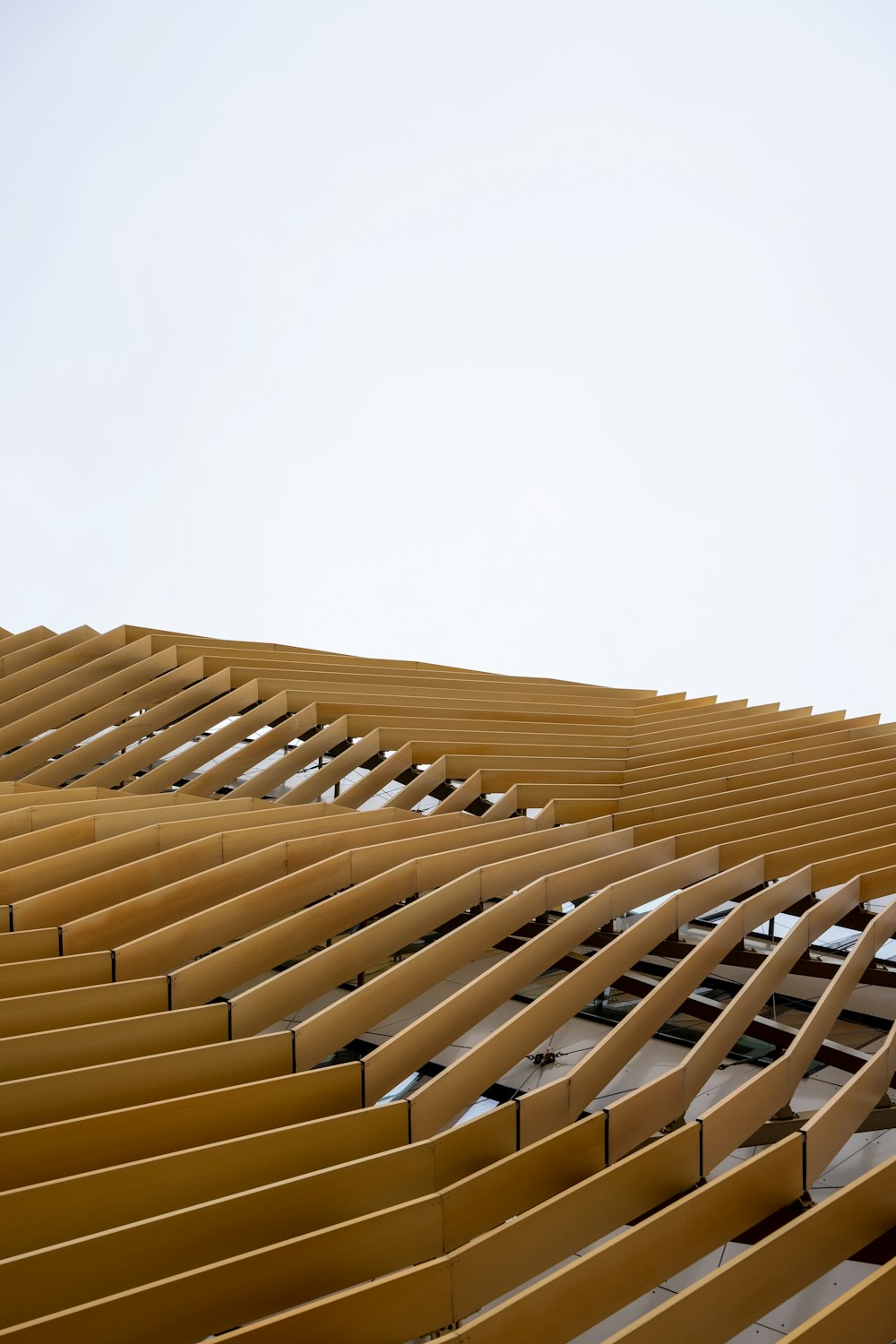 brown wooden roof under white sky during daytime