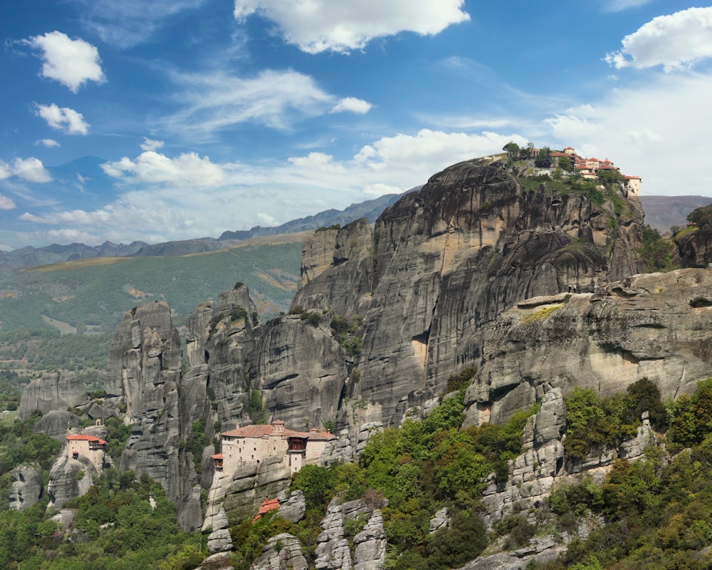 white and brown concrete houses on gray rocky mountain under blue sky during daytime