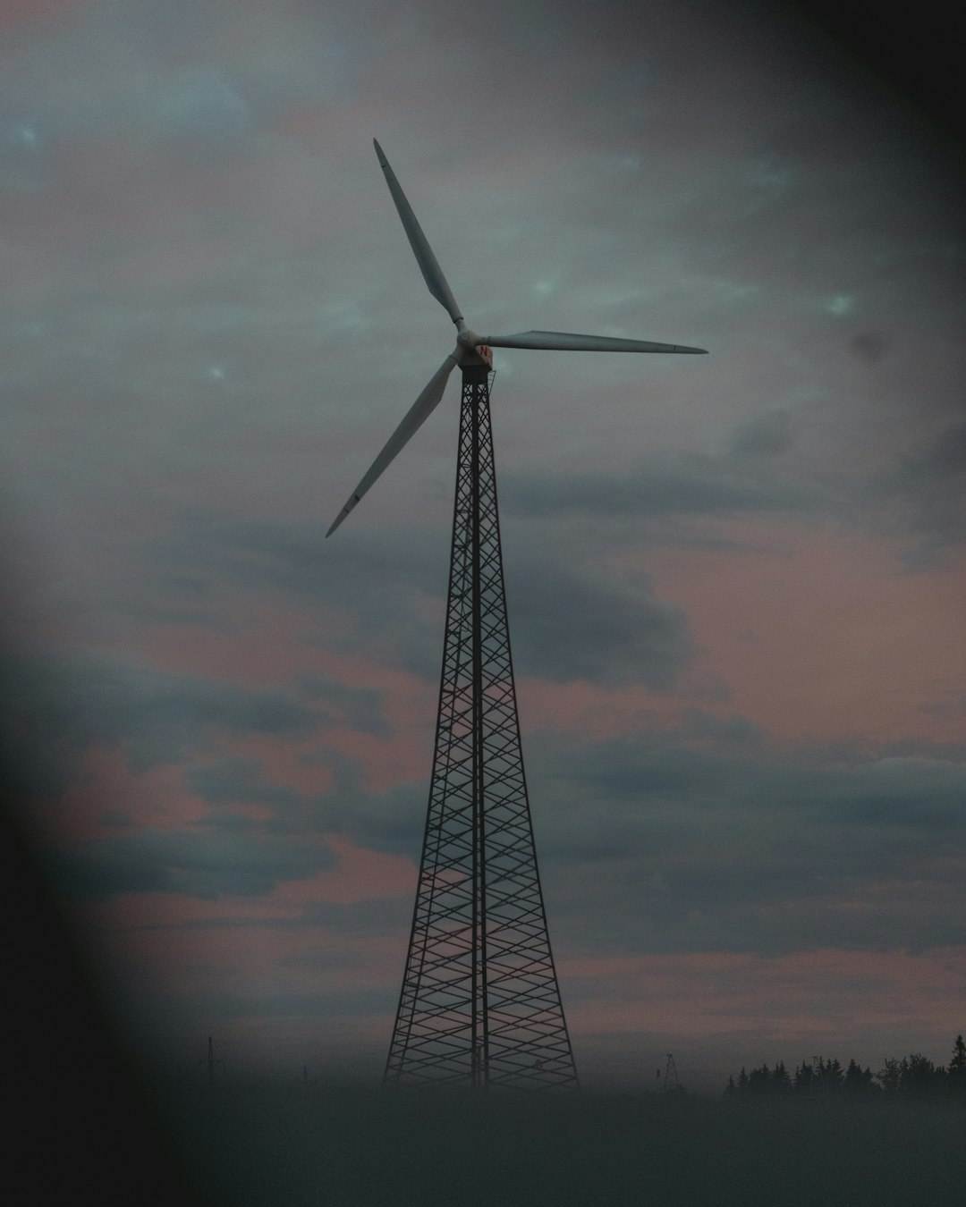 black windmill under orange and gray cloudy sky