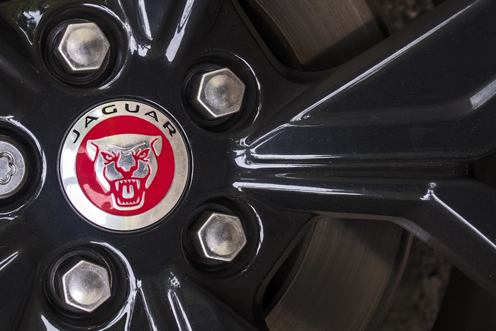 a close up of a wheel with a jaguar logo on it