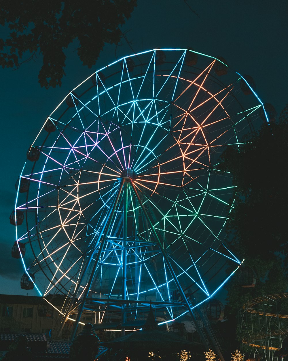 blau-weißes Riesenrad in der Nacht