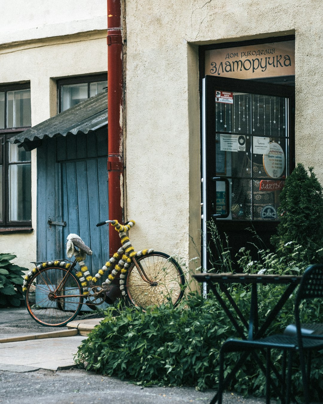 yellow bicycle parked beside black metal fence