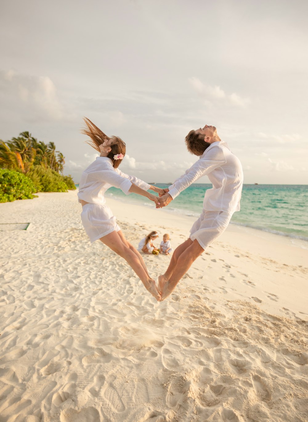 man and woman kissing on beach during daytime