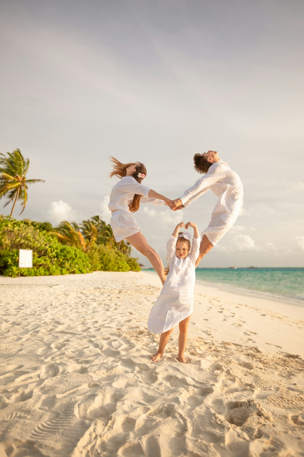 man and woman kissing on beach during daytime