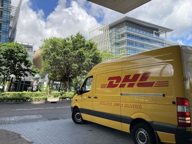 yellow van parked on sidewalk during daytime