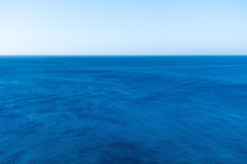 blue ocean under blue sky during daytime