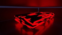 A rectangular, low platform is illuminated with a vivid red and black abstract pattern. The surrounding environment features muted red lighting, creating a dramatic contrast.