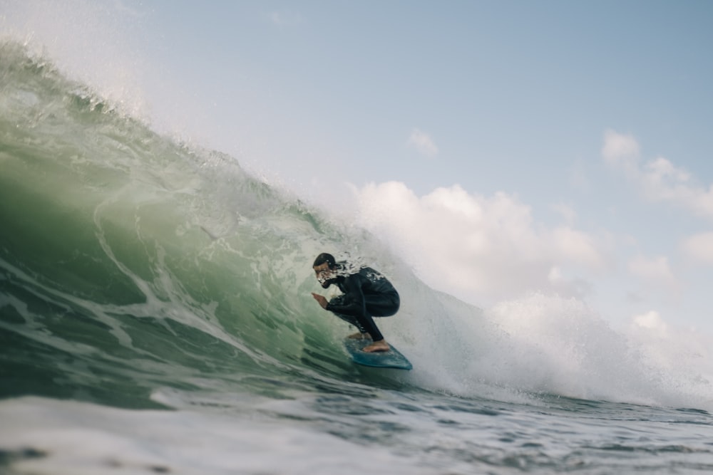 man surfing on sea waves during daytime