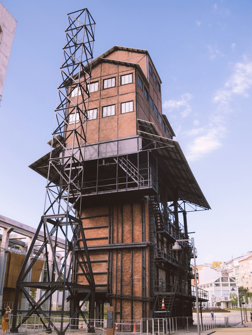 brown and black building near brown building during daytime