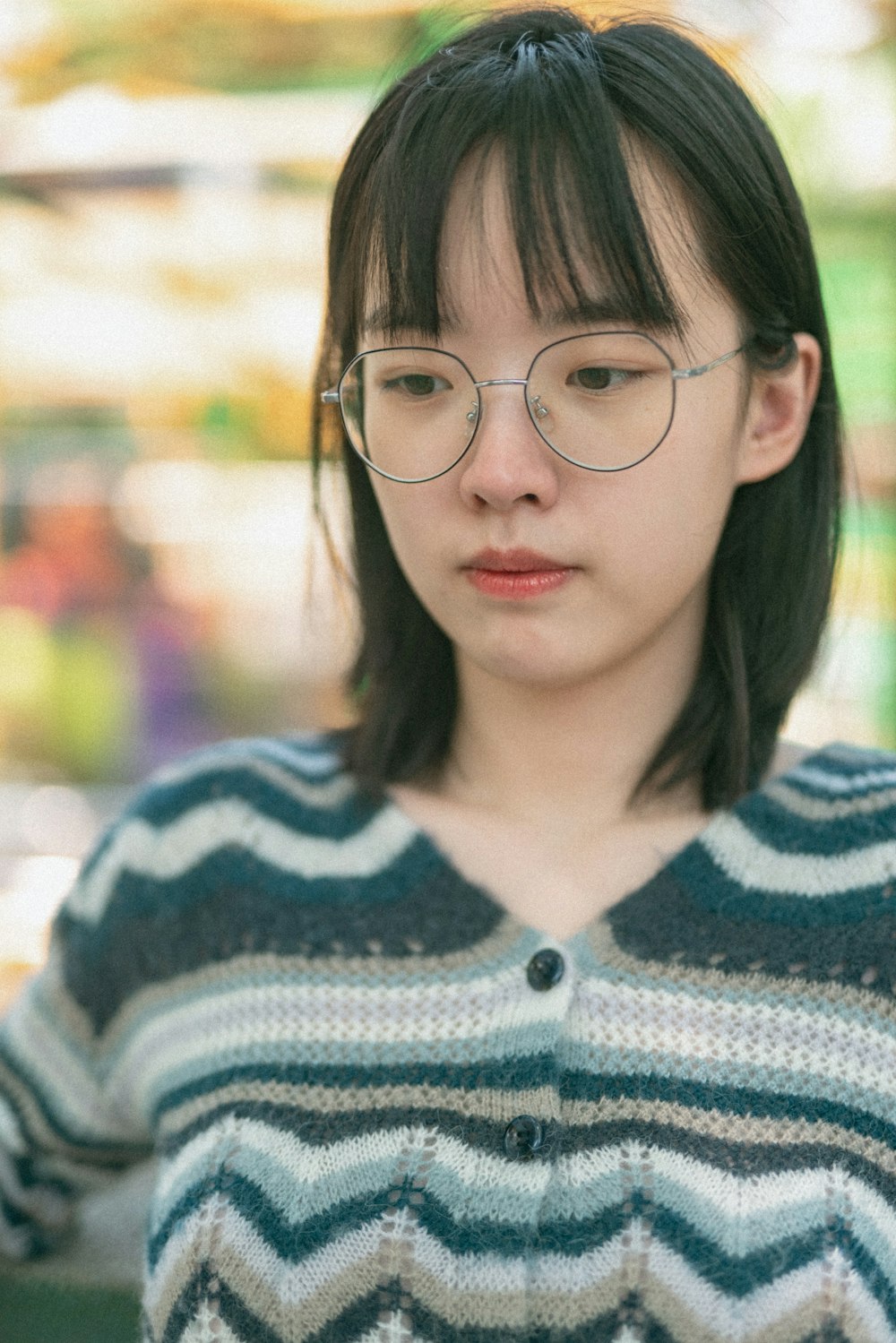 woman in blue and white striped knit sweater wearing black framed eyeglasses