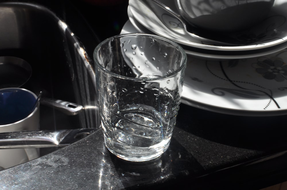 clear drinking glass on black table