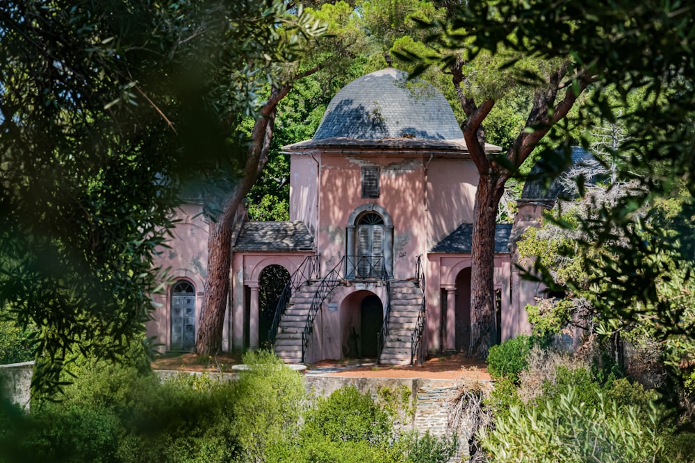 brown concrete building surrounded by green trees during daytime