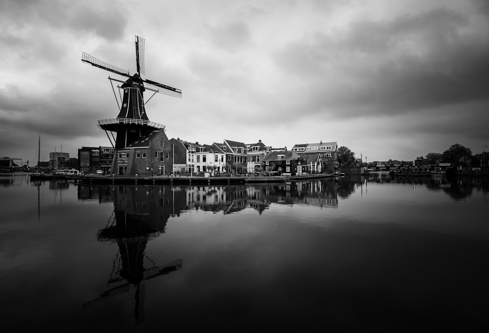 grayscale photo of building near body of water