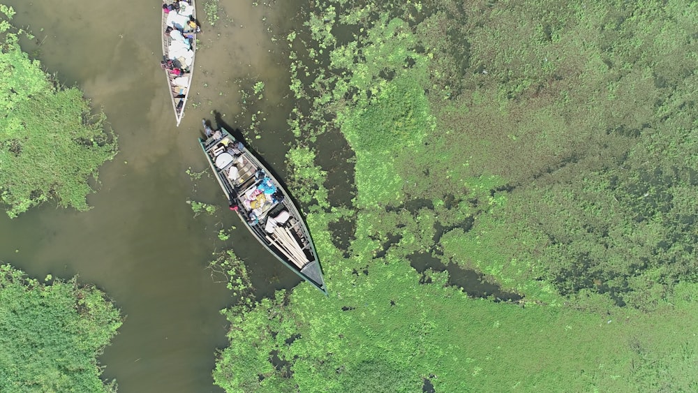 people riding on boat on river during daytime