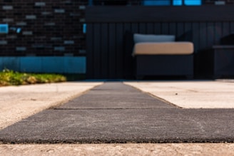 Picture of hardscapes in the yard of a private house with the house in the background.