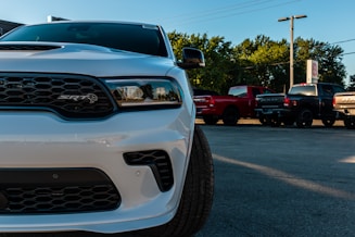 white ford car on parking lot during daytime