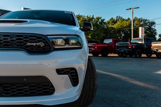 white ford car on parking lot during daytime