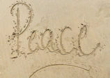 heart drawing on white sand