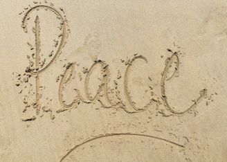 heart drawing on white sand
