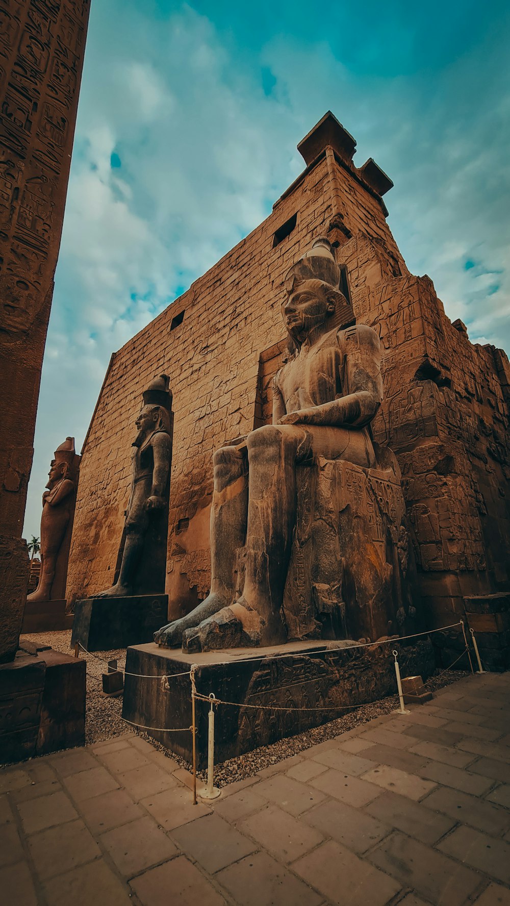 brown concrete statue under blue sky during daytime