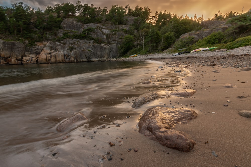 brown sand near body of water during daytime