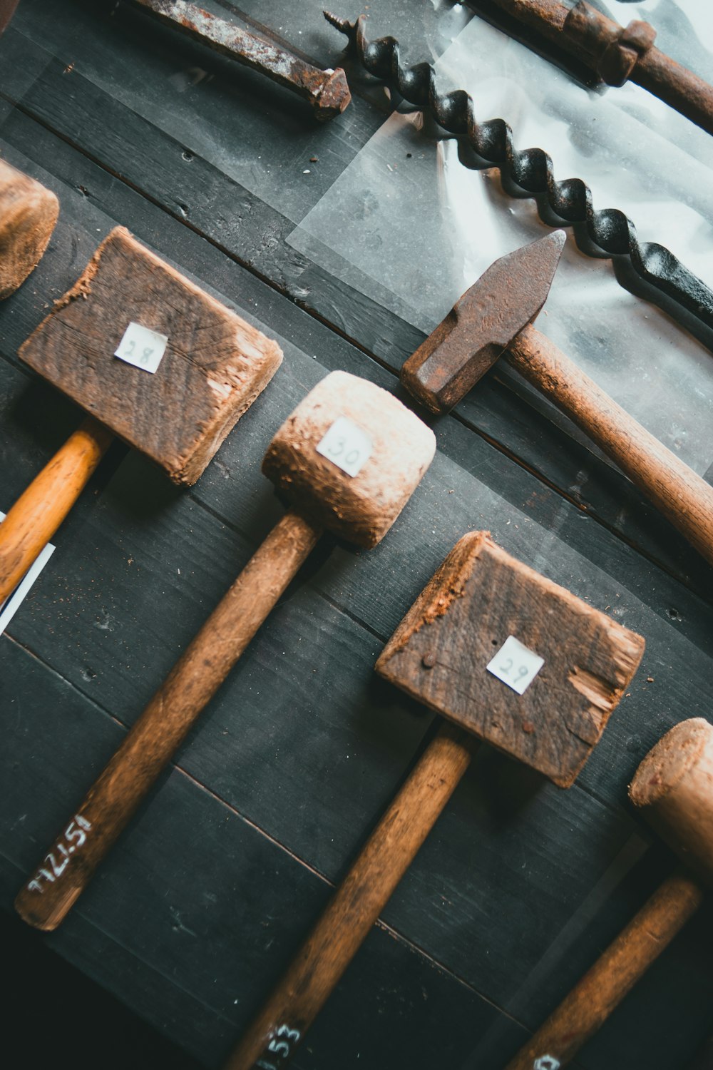 black and gray dumbbell and brown wooden handle