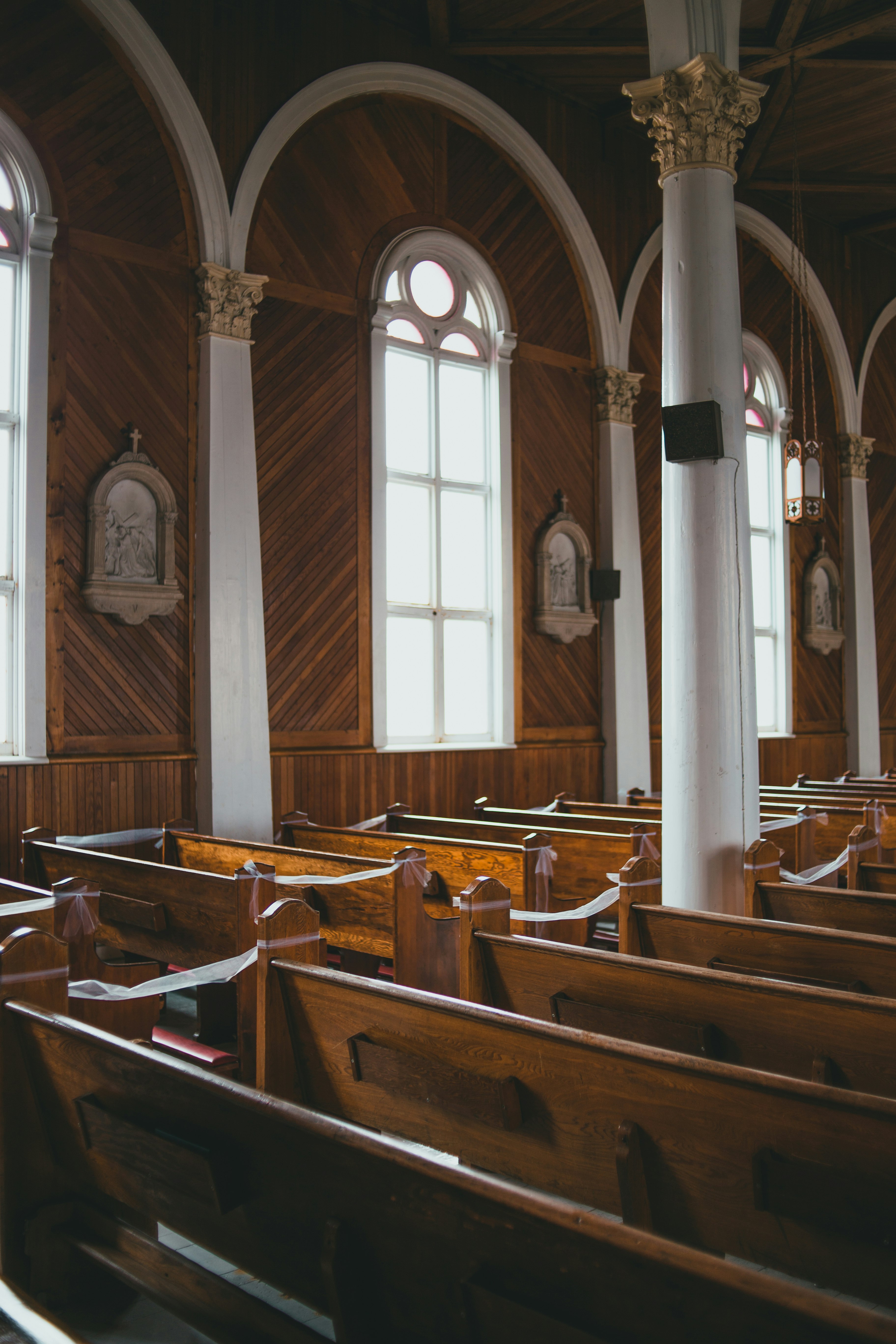 brown wooden chairs inside church