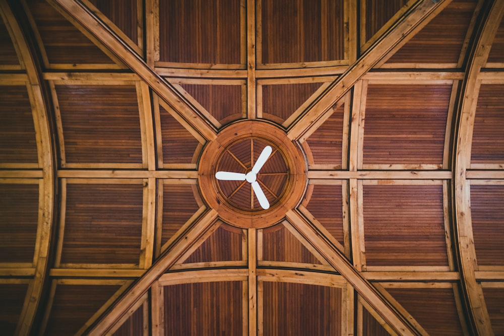 brown wooden ceiling with round black analog clock
