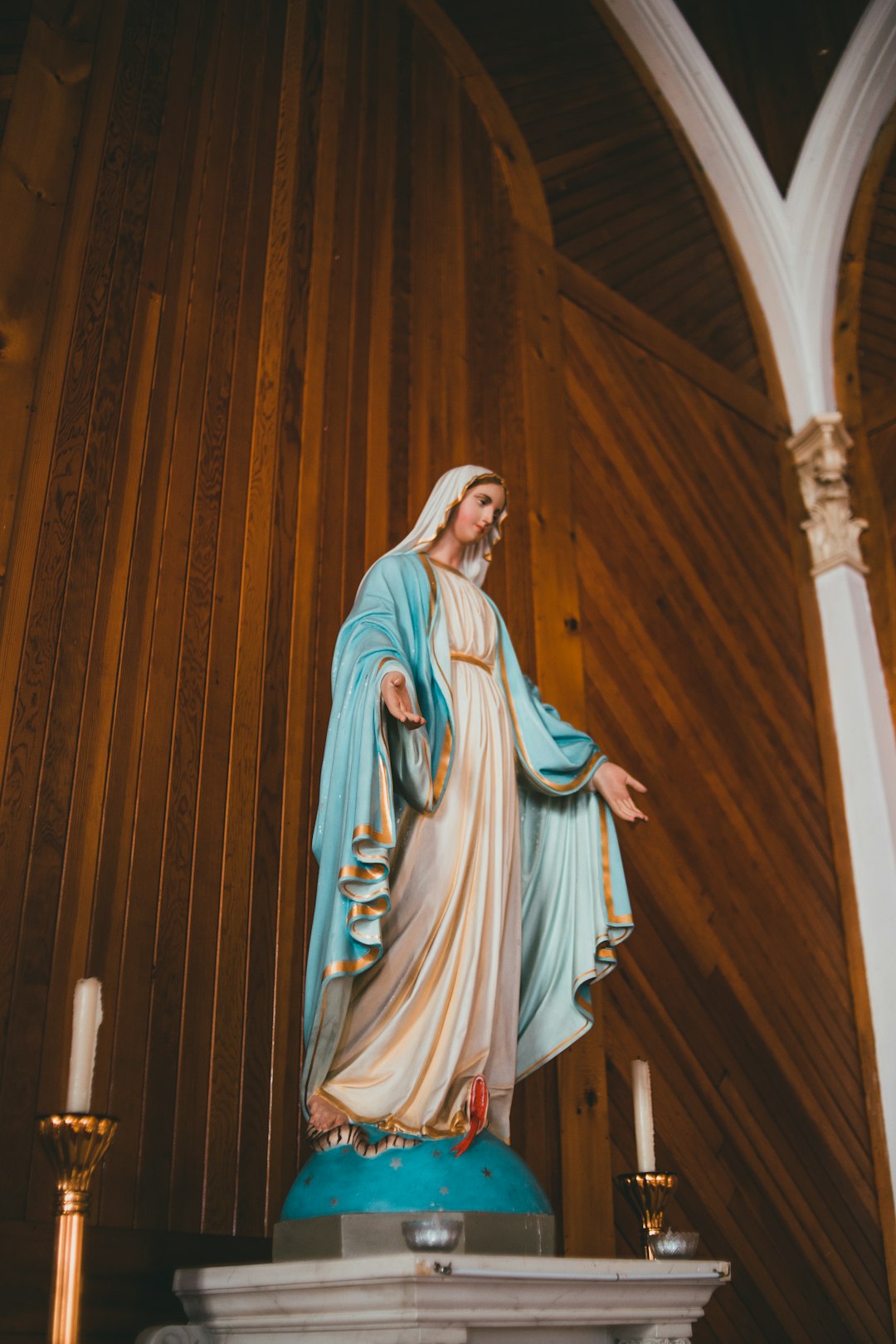 virgin mary statue in brown wooden room