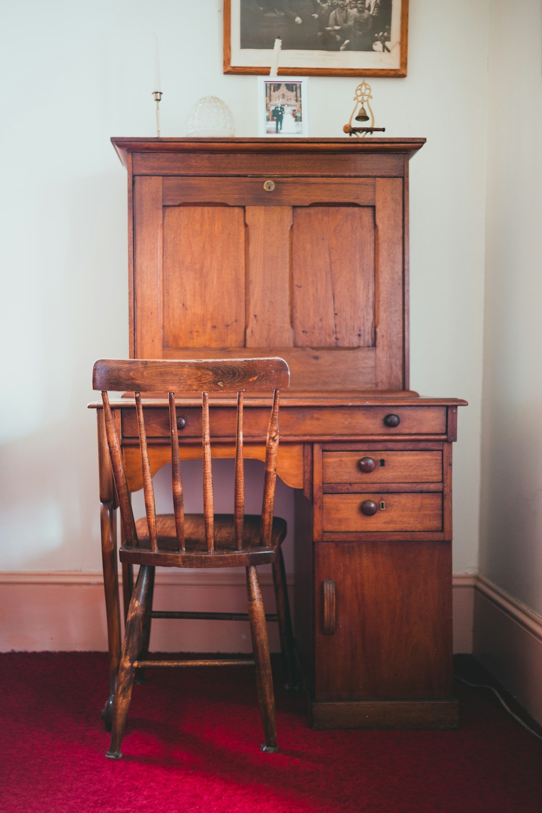 brown wooden chair beside brown wooden cabinet