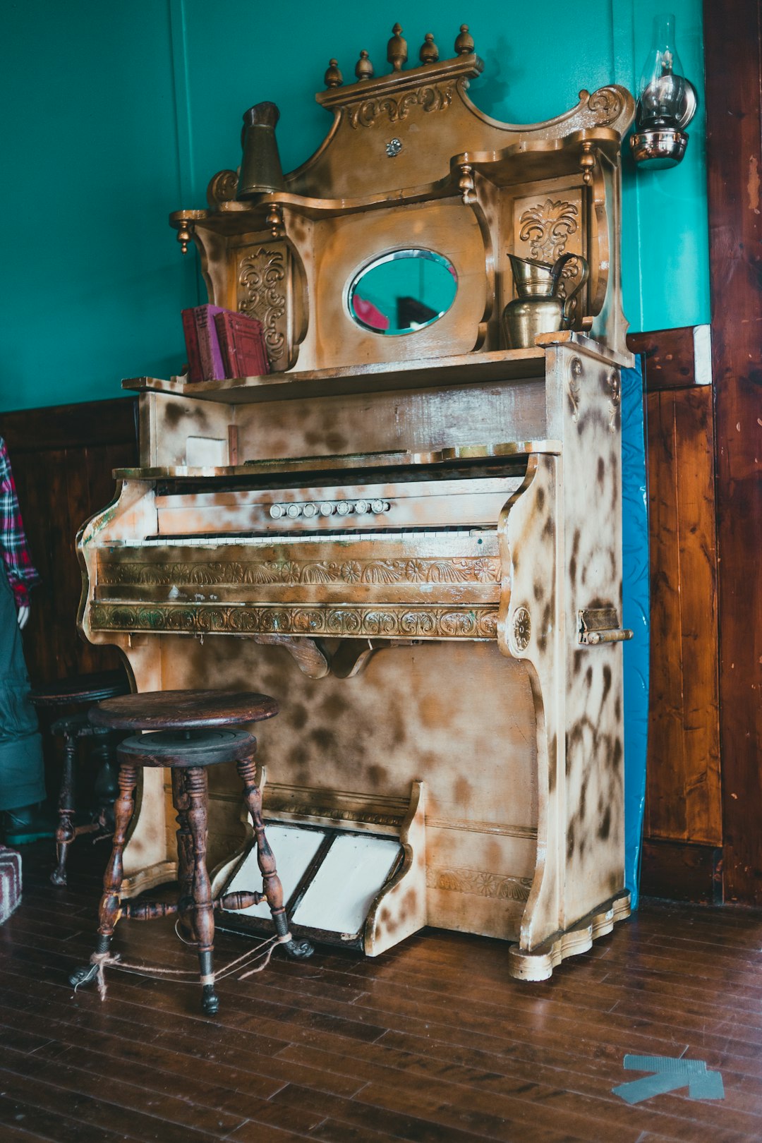 brown wooden upright piano with seat