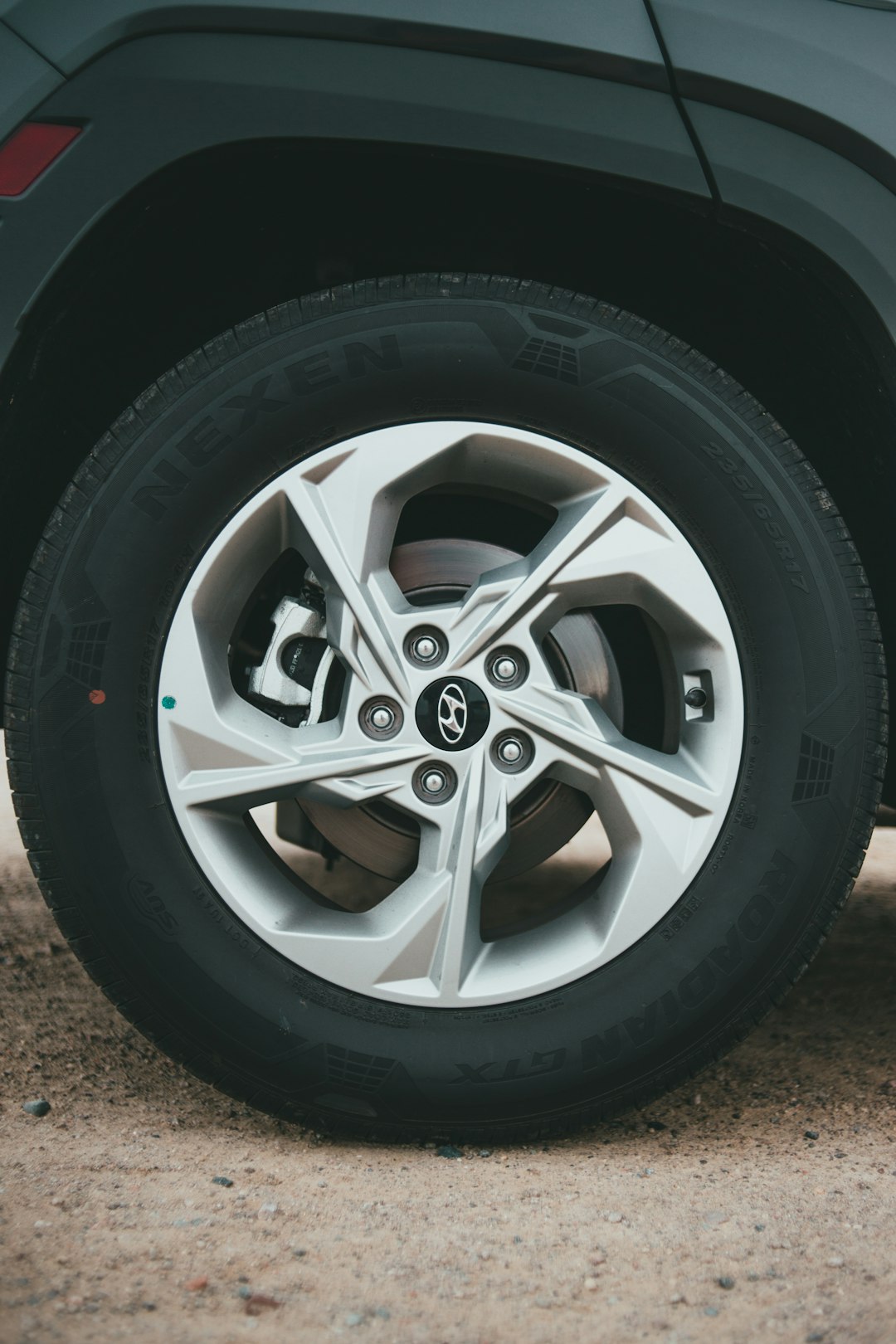 silver 5 spoke car wheel with tire