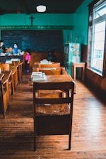 people sitting on brown wooden chairs