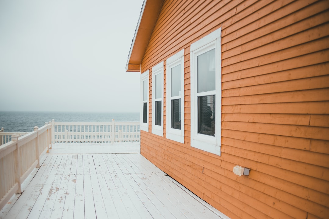 white wooden fence near brown wooden house during daytime