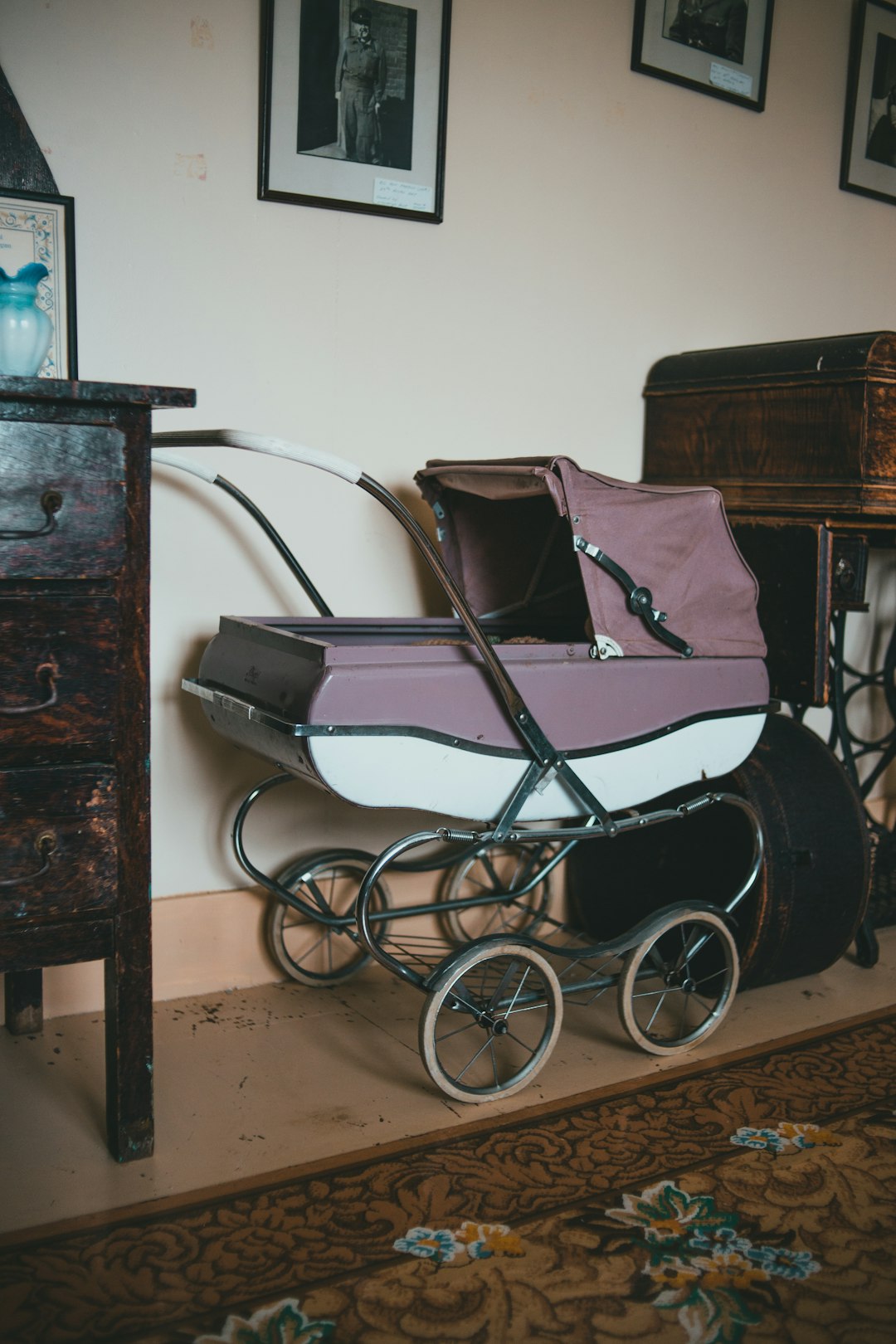 black and white wheelchair beside brown wooden cabinet