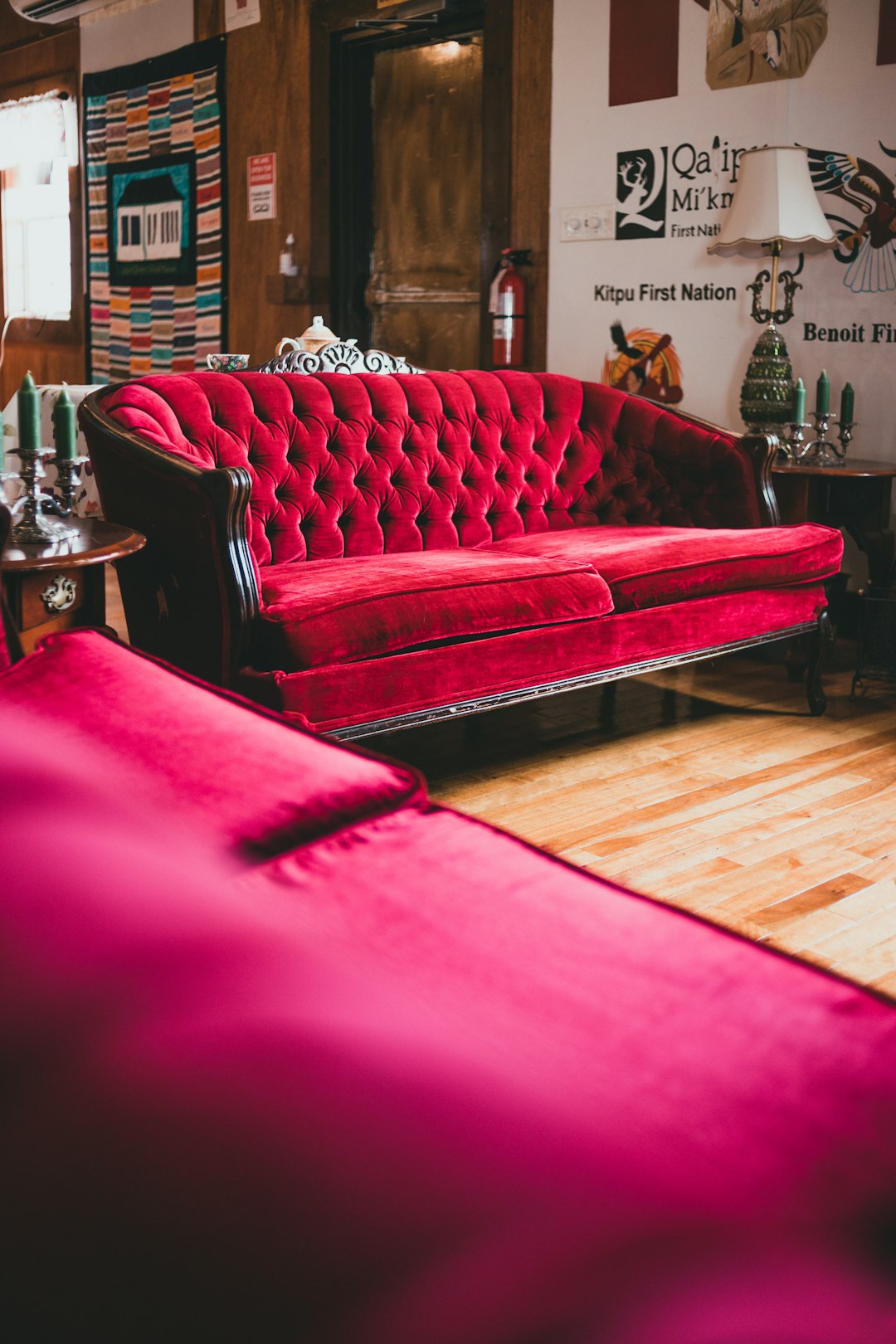 red sofa on brown wooden floor