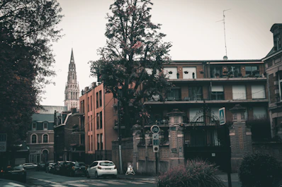 cars parked beside brown building during daytime