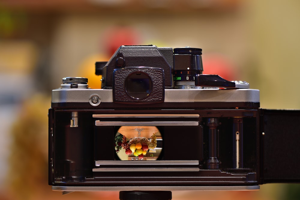 black and silver camera on black wooden table