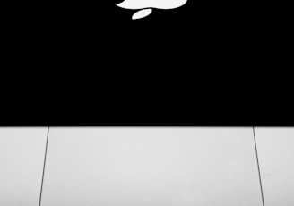 silver macbook on black surface