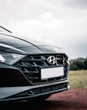 black mercedes benz car on green grass field during daytime